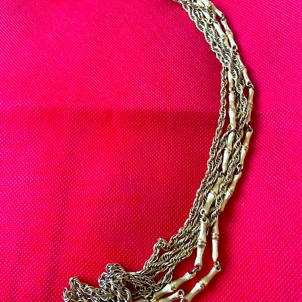 Triple strand long gold costume necklace.